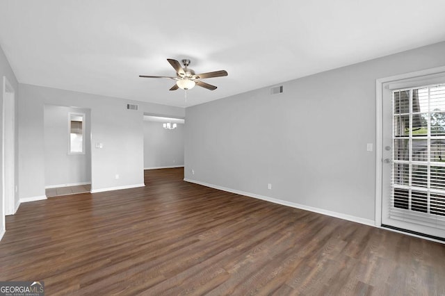 empty room featuring baseboards, a ceiling fan, and visible vents