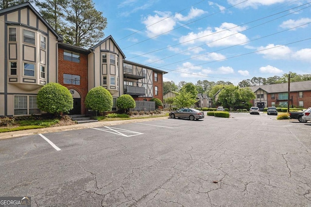 uncovered parking lot featuring a residential view