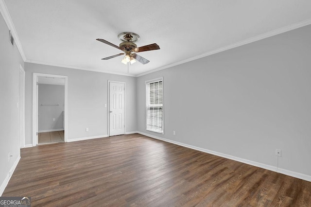 interior space with visible vents, ornamental molding, baseboards, dark wood finished floors, and ensuite bath