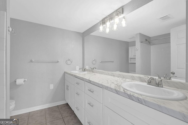 full bathroom featuring double vanity, visible vents, a sink, and tile patterned flooring