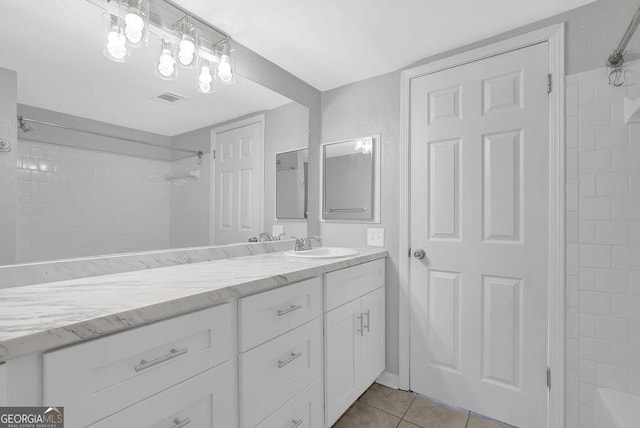 bathroom featuring visible vents, walk in shower, tile patterned flooring, and vanity