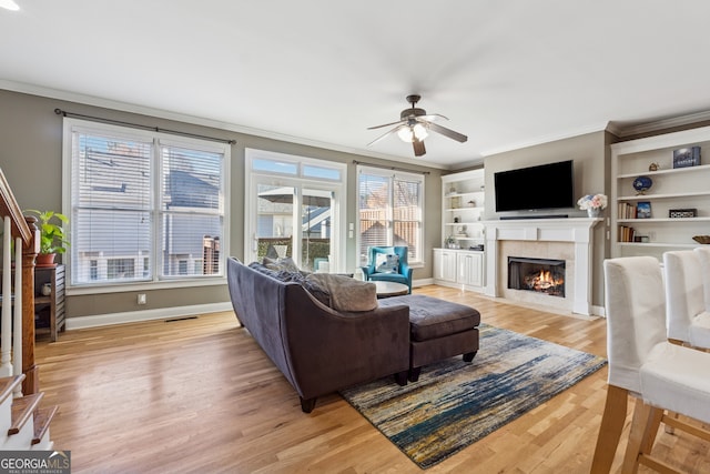 1236 Brickton Dr NW, Atlanta, GA 30318 - living room with crown molding, ceiling fan, light wood-style flooring, healthy amount of natural light, and a fireplace