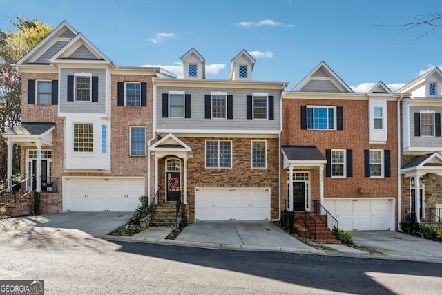 1236 Brickton Dr NW, Atlanta, GA 30318 - view of front of property with a garage, concrete driveway, and brick siding