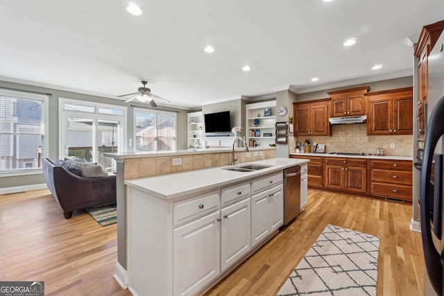 1236 Brickton Dr NW, Atlanta, GA 30318 - kitchen with a sink, stainless steel dishwasher, ornamental molding, under cabinet range hood, and open floor plan