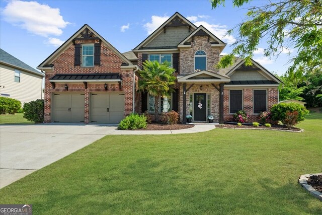 5950 Hidden Ridge Ct, Cumming, GA 30028 - craftsman-style home featuring a garage, driveway, a front lawn, brick siding, and a standing seam roof
