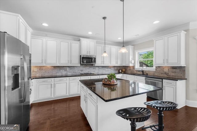 5950 Hidden Ridge Ct, Cumming, GA 30028 - kitchen featuring stainless steel appliances, dark wood-style floors, white cabinetry, a center island, and backsplash