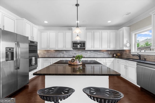 5950 Hidden Ridge Ct, Cumming, GA 30028 - kitchen with appliances with stainless steel finishes, a center island, white cabinetry, dark wood-style floors, and recessed lighting