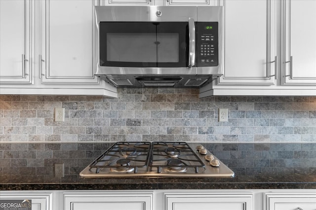 5950 Hidden Ridge Ct, Cumming, GA 30028 - kitchen with appliances with stainless steel finishes, white cabinets, and decorative backsplash