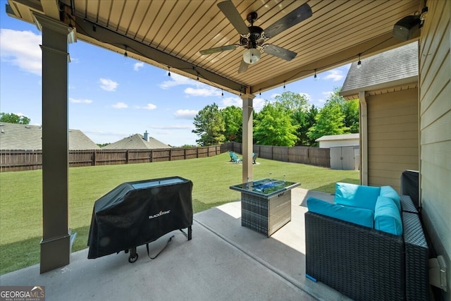 5950 Hidden Ridge Ct, Cumming, GA 30028 - fenced backyard featuring a patio area, area for grilling, a ceiling fan, an outdoor living space, and a shed