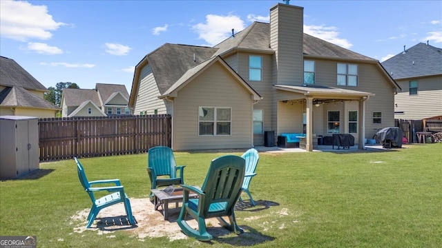 5950 Hidden Ridge Ct, Cumming, GA 30028 - rear view of house featuring an outdoor fire pit, a patio, a fenced backyard, ceiling fan, and a chimney