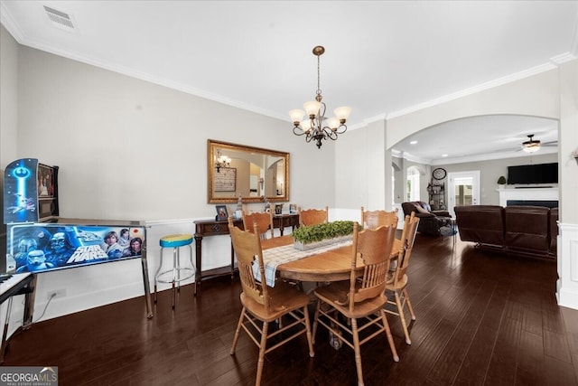 5950 Hidden Ridge Ct, Cumming, GA 30028 - dining room with arched walkways, hardwood / wood-style floors, crown molding, a ceiling fan, and a chandelier