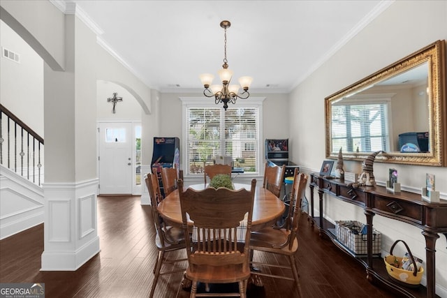 5950 Hidden Ridge Ct, Cumming, GA 30028 - dining space with a chandelier, arched walkways, ornamental molding, wainscoting, and wood finished floors