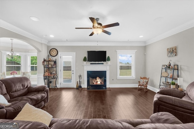 5950 Hidden Ridge Ct, Cumming, GA 30028 - living room with a ceiling fan, arched walkways, a lit fireplace, dark wood-style floors, and ornamental molding