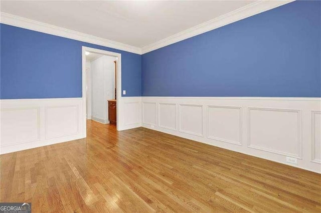 51 Sagemont Ct, Acworth, GA 30101 - unfurnished room with wood finished floors, a decorative wall, a wainscoted wall, and ornamental molding
