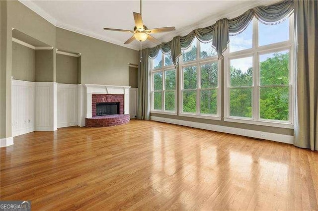 51 Sagemont Ct, Acworth, GA 30101 - unfurnished living room with a ceiling fan, wood finished floors, a fireplace, and crown molding