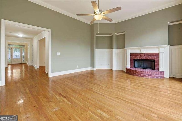 51 Sagemont Ct, Acworth, GA 30101 - unfurnished living room with light wood-style flooring, a brick fireplace, ornamental molding, and a ceiling fan
