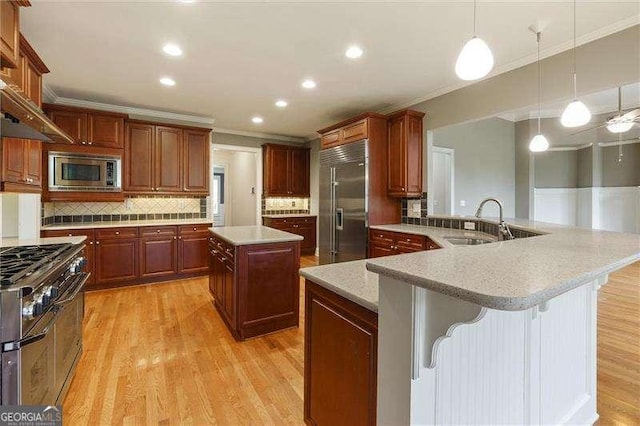 51 Sagemont Ct, Acworth, GA 30101 - kitchen with a center island, crown molding, a sink, decorative backsplash, and built in appliances