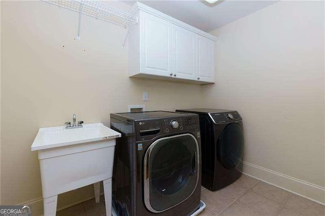 51 Sagemont Ct, Acworth, GA 30101 - laundry room featuring cabinet space, independent washer and dryer, baseboards, and light tile patterned floors