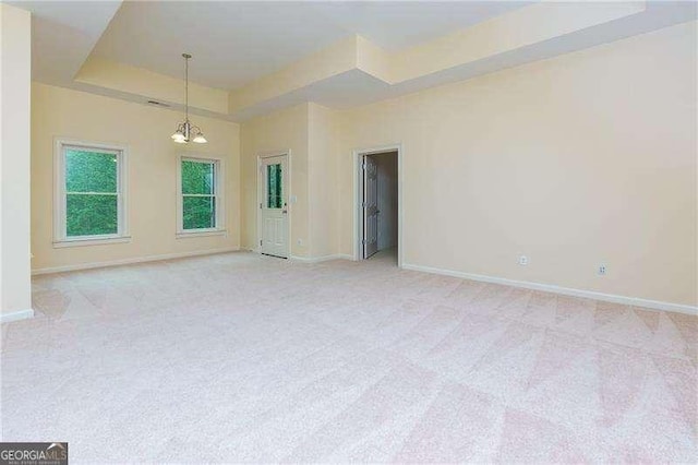 51 Sagemont Ct, Acworth, GA 30101 - empty room with light colored carpet, baseboards, a chandelier, and a raised ceiling