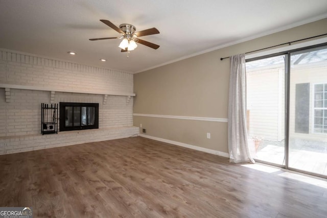 empty room featuring a ceiling fan, wood finished floors, and crown molding
