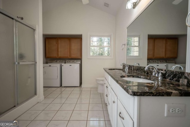 bathroom featuring baseboards, tile patterned floors, a sink, and double vanity