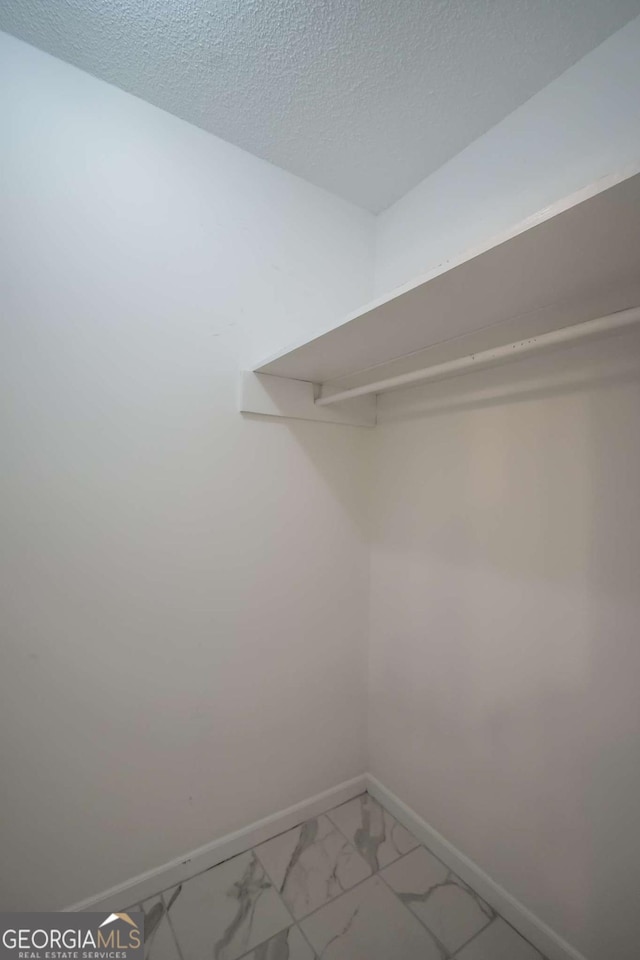 unfurnished bedroom featuring ceiling fan, baseboards, a closet, and carpet