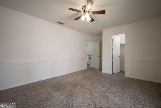 unfurnished bedroom featuring baseboards, visible vents, carpet, a ceiling fan, and a closet