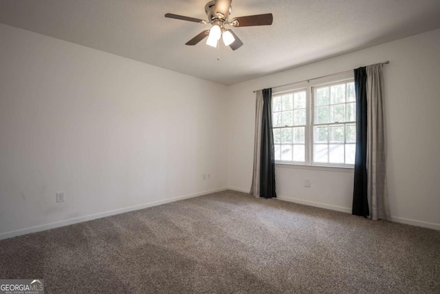 carpeted empty room with baseboards and ceiling fan