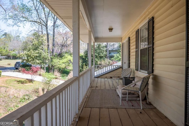 view of property exterior with fence, a balcony, and brick siding