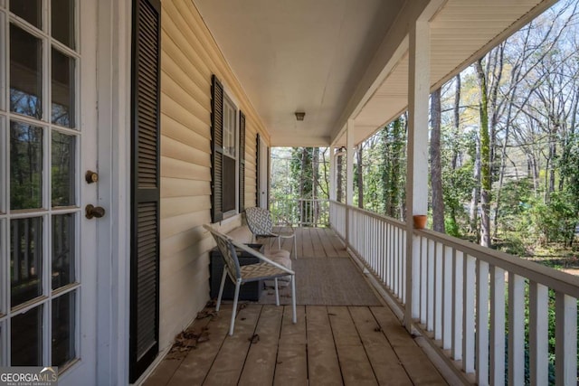 back of house featuring french doors and covered porch