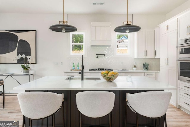 156 Martha Ave NE, Atlanta, GA 30317 - kitchen featuring a sink, plenty of natural light, light countertops, and white cabinets