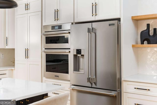 156 Martha Ave NE, Atlanta, GA 30317 - kitchen with stainless steel appliances, open shelves, decorative backsplash, and white cabinetry