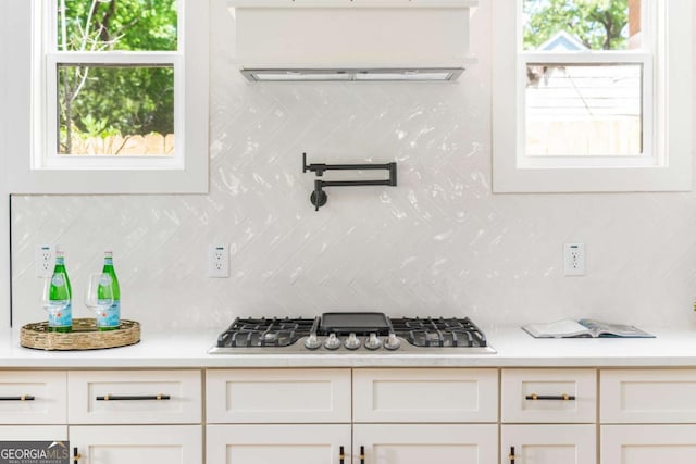 156 Martha Ave NE, Atlanta, GA 30317 - kitchen featuring stainless steel gas stovetop, tasteful backsplash, light countertops, and white cabinets