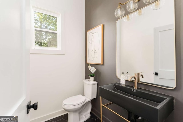 156 Martha Ave NE, Atlanta, GA 30317 - half bathroom featuring toilet, a sink, baseboards, and tile patterned floors
