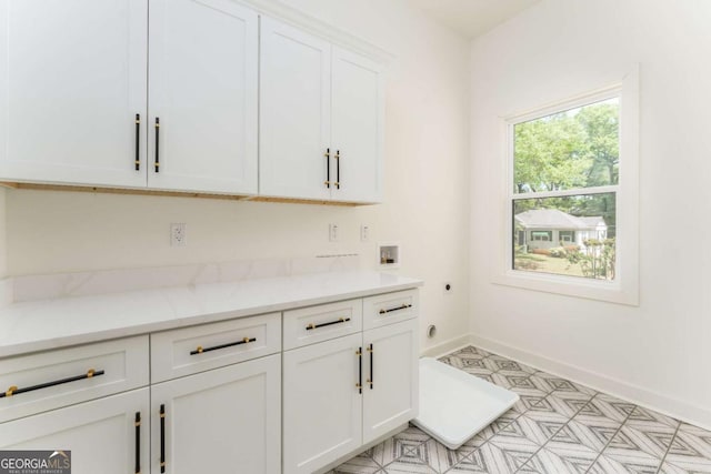 156 Martha Ave NE, Atlanta, GA 30317 - laundry area with cabinet space, hookup for an electric dryer, washer hookup, light floors, and baseboards