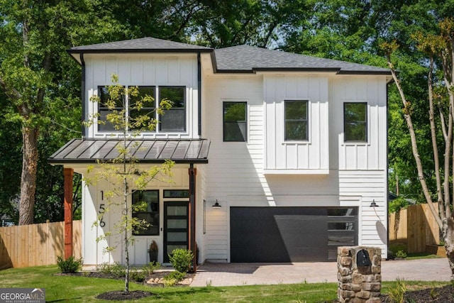 156 Martha Ave NE, Atlanta, GA 30317 - view of front of house with fence, a garage, a standing seam roof, and board and batten siding