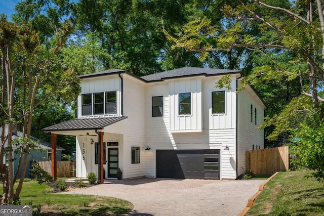 156 Martha Ave NE, Atlanta, GA 30317 - view of front of house with board and batten siding, fence, and an attached garage