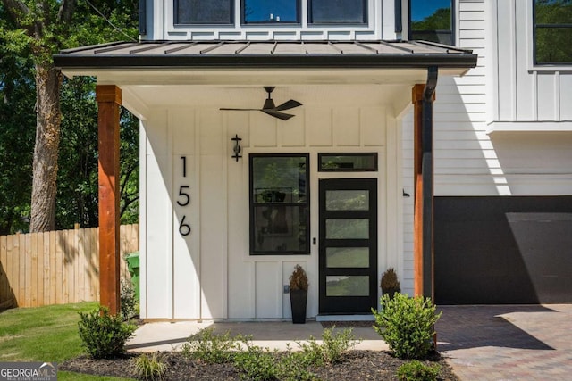 156 Martha Ave NE, Atlanta, GA 30317 - property entrance with board and batten siding, a standing seam roof, fence, and metal roof