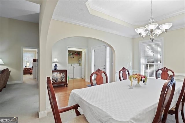 152 Cooper Creek Dr, Dallas, GA 30157 - dining space with washing machine and dryer, arched walkways, crown molding, and a chandelier