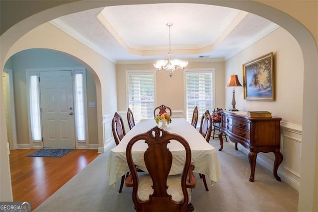 152 Cooper Creek Dr, Dallas, GA 30157 - dining space with an inviting chandelier, a raised ceiling, arched walkways, crown molding, and carpet flooring