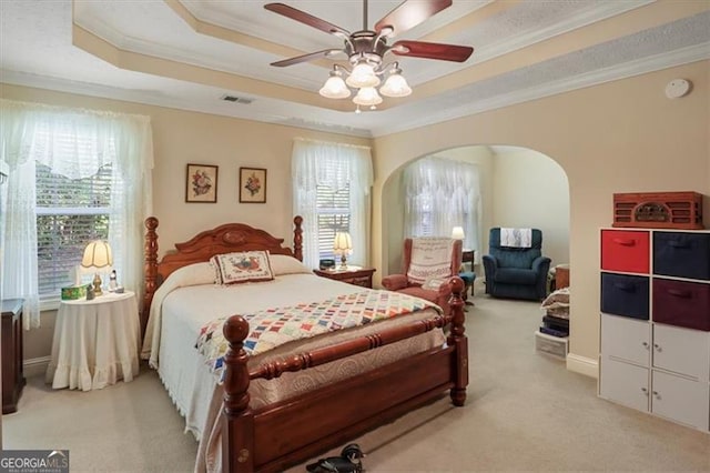 152 Cooper Creek Dr, Dallas, GA 30157 - bedroom with arched walkways, a raised ceiling, light colored carpet, and ornamental molding