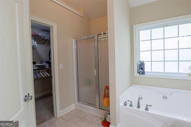 152 Cooper Creek Dr, Dallas, GA 30157 - bathroom featuring a bath, a healthy amount of sunlight, a walk in closet, and a stall shower