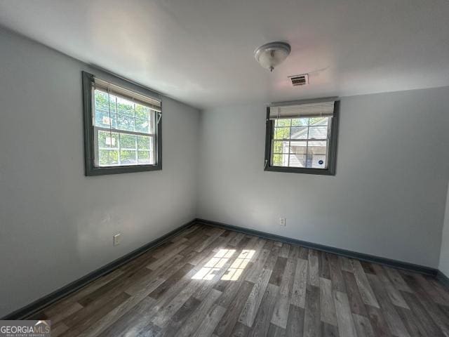 2016 Conrad Ave SE, Atlanta, GA 30315 - spare room featuring baseboards, wood finished floors, and visible vents