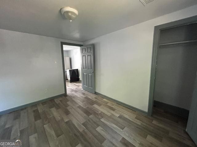 2016 Conrad Ave SE, Atlanta, GA 30315 - unfurnished bedroom with visible vents, baseboards, wood finished floors, and a closet