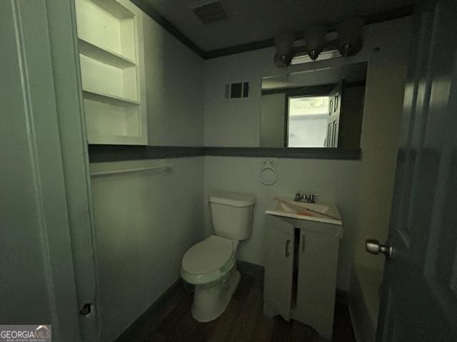 2016 Conrad Ave SE, Atlanta, GA 30315 - half bathroom with wood finished floors, visible vents, toilet, and a sink