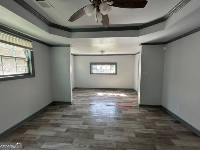 2016 Conrad Ave SE, Atlanta, GA 30315 - unfurnished room featuring visible vents, a ceiling fan, wood finished floors, and ornamental molding