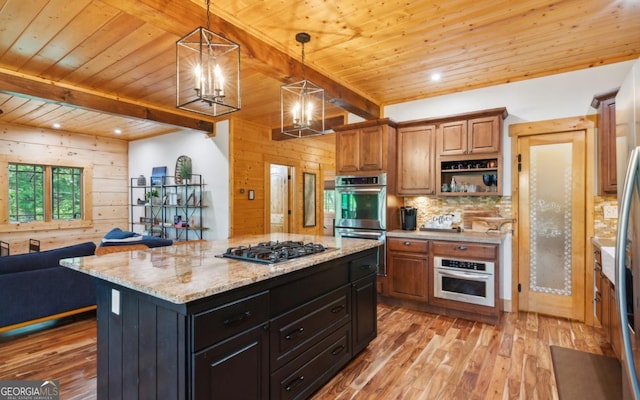 kitchen featuring appliances with stainless steel finishes, wood ceiling, open floor plan, a chandelier, and light wood-style flooring