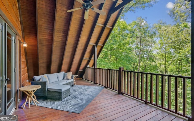 wooden terrace featuring a ceiling fan and an outdoor living space