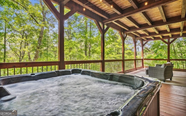 wooden terrace with a hot tub