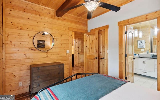 bedroom with wooden walls, beam ceiling, wood ceiling, tile patterned flooring, and a sink